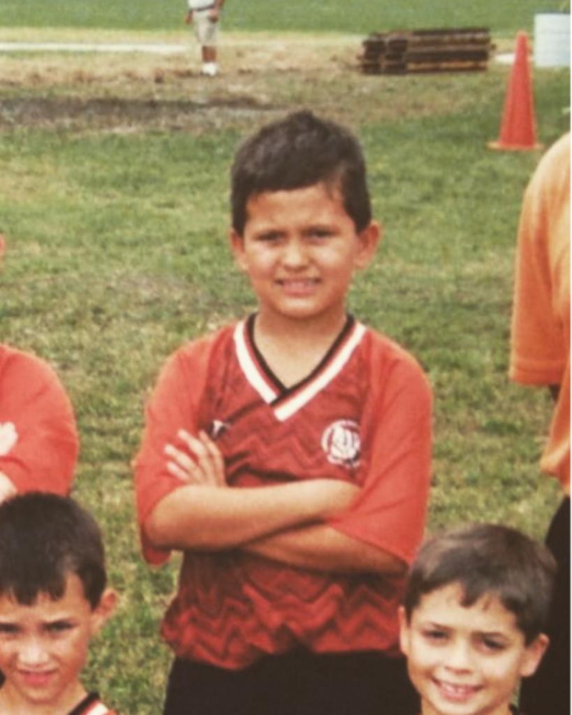 Lukas as a child wearing a soccer uniform