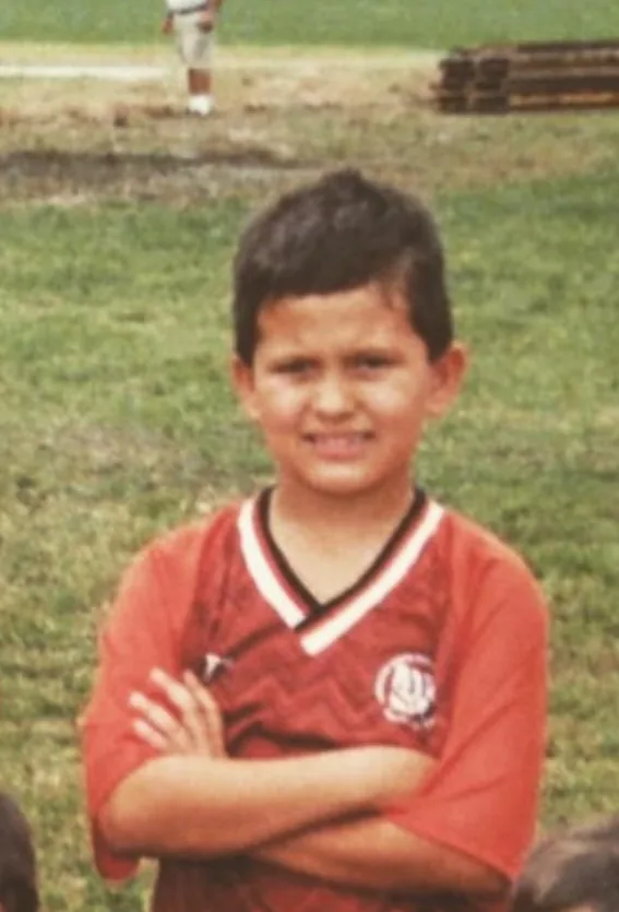 Lukas as a child wearing a soccer uniform